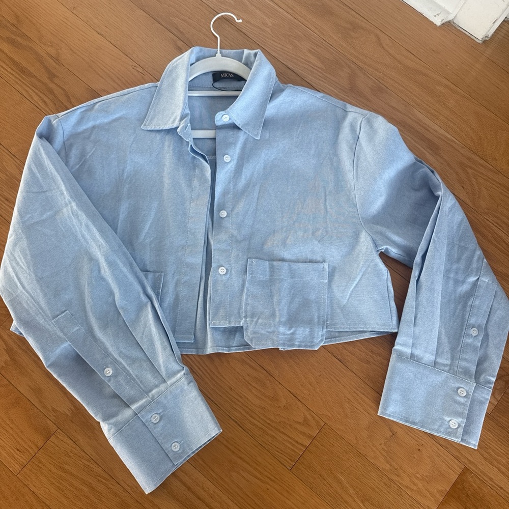 Cropped light blue button down shirt.